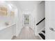 Bright hallway with light wood floors and staircase leading to the upper level at 55 Tidy Island Blvd, Bradenton, FL 34210