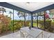 Screened lanai with dining area and lush landscaping at 55 Tidy Island Blvd, Bradenton, FL 34210