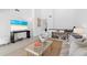 Cozy living room with neutral decor, featuring a TV, sofa, and glass coffee table in a well-lit space at 55 Tidy Island Blvd, Bradenton, FL 34210