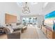 Bright living room with water views, a modern chandelier, and comfortable seating at 55 Tidy Island Blvd, Bradenton, FL 34210