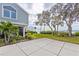 Home's patio area with lush green lawn that slopes down toward the waterfront at 55 Tidy Island Blvd, Bradenton, FL 34210