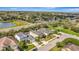 An aerial view captures a neighborhood, showcasing attractive homes, verdant landscaping, and community tennis courts at 5718 Westhaven Cv, Bradenton, FL 34203