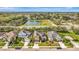 Aerial view of a home in a well-kept neighborhood with mature trees and landscaping near a pond and park at 5718 Westhaven Cv, Bradenton, FL 34203