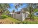 Fenced backyard with palms and mature trees offers privacy and a serene outdoor space at 5718 Westhaven Cv, Bradenton, FL 34203