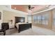 A primary bedroom with a decorative ceiling, a ceiling fan, large windows and a carpeted floor at 5718 Westhaven Cv, Bradenton, FL 34203