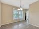 Bright dining area with natural light, an elegant chandelier, and easy access to the entryway and living spaces at 5718 Westhaven Cv, Bradenton, FL 34203