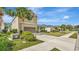 Street view of the property highlighting the manicured lawn, front of home, garage, and mature palm trees at 5718 Westhaven Cv, Bradenton, FL 34203