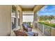 Inviting front porch showcasing wicker furniture and a relaxing outdoor seating area with a view at 5718 Westhaven Cv, Bradenton, FL 34203