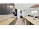 Granite countertops and dark cabinets highlight this modern kitchen with stainless steel appliances and breakfast bar at 5718 Westhaven Cv, Bradenton, FL 34203