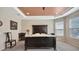 Primary bedroom featuring a tray ceiling, neutral paint, and an elegant rug and furniture at 5718 Westhaven Cv, Bradenton, FL 34203