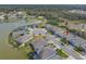 Aerial view of house featuring well-kept lawn, lake views and landscaping at 5821 Hevena Ct, Palmetto, FL 34221