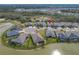 Aerial view of home with lake view, landscaping, and lush green lawn at 5821 Hevena Ct, Palmetto, FL 34221