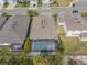 Aerial view of a single-Gathering home featuring a screened pool, landscaping, and neutral-toned roofing at 5821 Hevena Ct, Palmetto, FL 34221