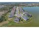 Aerial view of home located on pond featuring lush landscaping and lawn at 5821 Hevena Ct, Palmetto, FL 34221