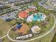 Bird's-eye view of the community amenities including a pool, clubhouse, playground, and ample parking in a scenic setting at 5821 Hevena Ct, Palmetto, FL 34221