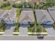 Aerial view of home featuring 2 car garage, lush landscaping, and lawn at 5821 Hevena Ct, Palmetto, FL 34221