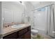 Bathroom featuring a single sink vanity, toilet, and shower-tub combination with white tiled walls at 5821 Hevena Ct, Palmetto, FL 34221