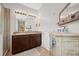 Bathroom with double sink vanity, granite countertop, stylish fixtures, and a decorative cabinet at 5821 Hevena Ct, Palmetto, FL 34221