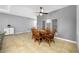 Cozy dining area with dark ceiling fan and neutral wall colors at 5821 Hevena Ct, Palmetto, FL 34221