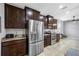 Modern kitchen featuring stainless steel appliances, granite counters, and dark wood cabinetry at 5821 Hevena Ct, Palmetto, FL 34221