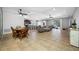 Spacious living room featuring tile floors, ceiling fans, and a view of the pool area at 5821 Hevena Ct, Palmetto, FL 34221