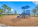 Bright blue playground with a slide, swing set and climbing structure with a mulch ground cover at 5821 Hevena Ct, Palmetto, FL 34221