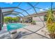 Wonderful outdoor living space with a screened pool, ample seating, and lush tropical surroundings at 5821 Hevena Ct, Palmetto, FL 34221