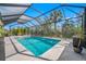 Beautiful screened pool area with clear blue water, fountain features, and ample patio space at 5821 Hevena Ct, Palmetto, FL 34221