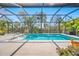 Spacious screened pool area with fountain features, clear blue water, and mature landscaping at 5821 Hevena Ct, Palmetto, FL 34221