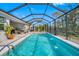 Sparkling pool with fountains inside a screened enclosure and a comfortable lounging area at 5821 Hevena Ct, Palmetto, FL 34221