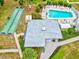 Aerial view of a complex featuring pool and shuffleboard court, offering a variety of recreational activities for residents at 5855 Palm Ln # B21, Bradenton, FL 34207