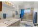 Bathroom featuring gold shower doors, a framed mirror, and blue accents at 5855 Palm Ln # B21, Bradenton, FL 34207