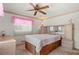 Bedroom featuring wooden furniture, neutral bedding, and a ceiling fan for comfortable living at 5855 Palm Ln # B21, Bradenton, FL 34207