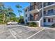 Three-story apartment exterior view featuring outdoor staircases, balconies, and parking at 5855 Palm Ln # B21, Bradenton, FL 34207