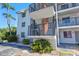 Condo building exterior with stairway and landscaping on a sunny day at 5855 Palm Ln # B21, Bradenton, FL 34207