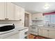 Well-lit kitchen with white cabinetry, laminate countertops, and a microwave on the counter at 5855 Palm Ln # B21, Bradenton, FL 34207