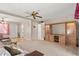 Inviting living room with a ceiling fan, an entertainment center, and a cozy carpet at 5855 Palm Ln # B21, Bradenton, FL 34207