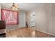 Living Room featuring wood laminate flooring, large window with curtains and an entry door at 5855 Palm Ln # B21, Bradenton, FL 34207