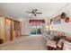 Bright carpeted Living Room with ceiling fan, vintage furniture and screened porch at 5855 Palm Ln # B21, Bradenton, FL 34207