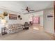 Carpeted Living Room with ceiling fan, vintage furniture and doorway to front room at 5855 Palm Ln # B21, Bradenton, FL 34207