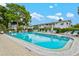 Community swimming pool featuring lounge chairs, umbrellas, and clear blue water for residents to enjoy at 5855 Palm Ln # B21, Bradenton, FL 34207