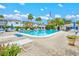 Relaxing community pool area featuring comfortable lounge chairs and lush landscaping for a serene atmosphere at 5855 Palm Ln # B21, Bradenton, FL 34207