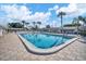 Large community pool with palm tree views, lounge chairs, and well-maintained surroundings at 6016 Hibiscus Dr, Bradenton, FL 34207