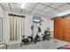 Recreation room with an elliptical machine, exercise bike, mounted TV, and shuffleboard equipment at 6016 Hibiscus Dr, Bradenton, FL 34207