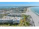 This aerial view captures the condo community, beaches, and ocean views of the property at 6500 Sunset Way # 311, St Pete Beach, FL 33706