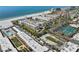 Aerial view showcasing the beachfront condo complex with tennis courts and beach access at 6500 Sunset Way # 311, St Pete Beach, FL 33706