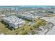 Aerial view of the condo complex with beach access, pool, and tennis courts offering an active lifestyle at 6500 Sunset Way # 311, St Pete Beach, FL 33706