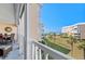 Relaxing balcony view of manicured lawn, the beach, and Gulf of Mexico from elevated condo at 6500 Sunset Way # 311, St Pete Beach, FL 33706