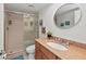 Bright, tiled bathroom features a glass enclosed shower and granite vanity at 6500 Sunset Way # 311, St Pete Beach, FL 33706