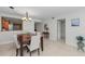 Charming dining room with a wooden table, neutral upholstered chairs, and a stylish chandelier at 6500 Sunset Way # 311, St Pete Beach, FL 33706